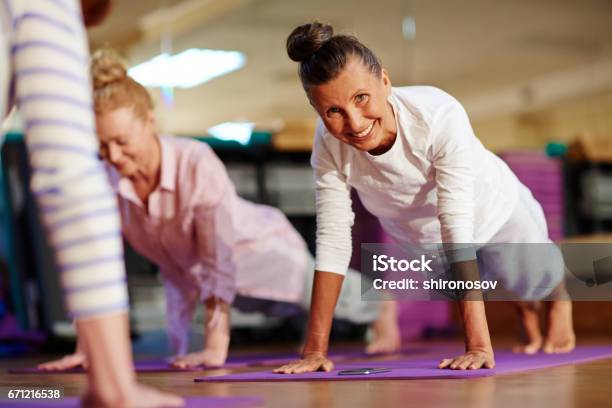 Pushing Up Stock Photo - Download Image Now - Senior Adult, Pilates, Yoga