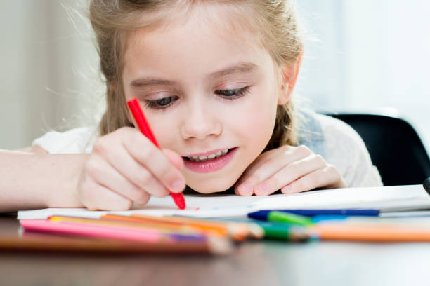 istock Happy mother and daughter drawing at home 671216706
