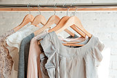 istock Clothes hang on clothing rack 671217220