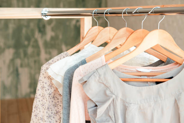 istock Clothes hang on clothing rack 671217222