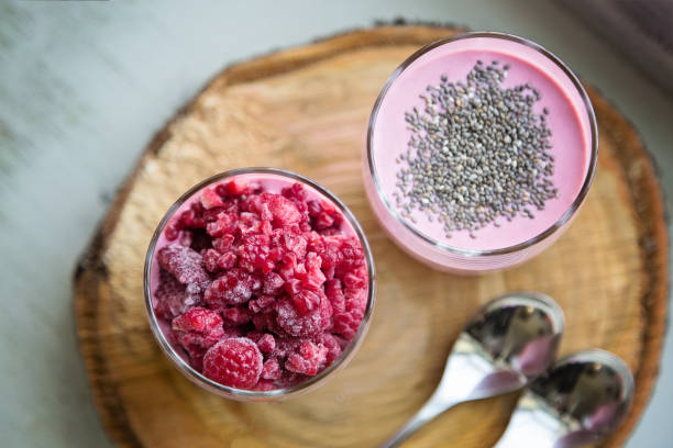 Chia raspberies cottage cheese breakfast in two small transparent glasses