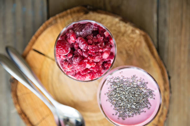 istock Chia raspberies cottage cheese breakfast in two small transparent glasses 671218492