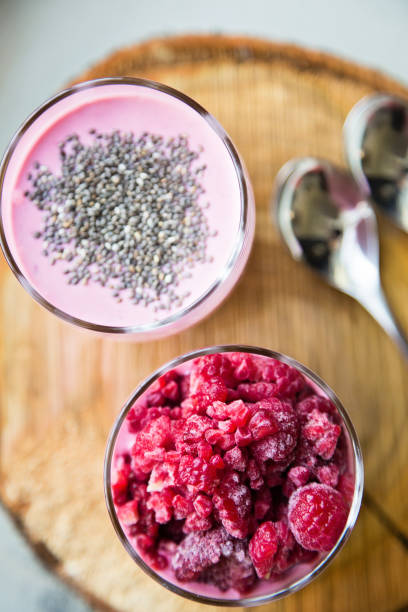 istock Chia raspberies cottage cheese breakfast in two small transparent glasses 671223382