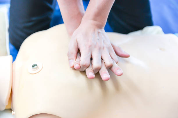 istock Basic Life Support of Demonstrating chest compressions on CPR doll 671228294
