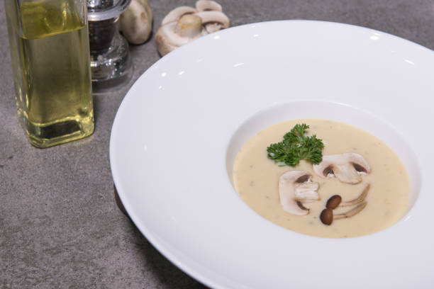 istock Mushroom cream soup in white dish on the table 671228466