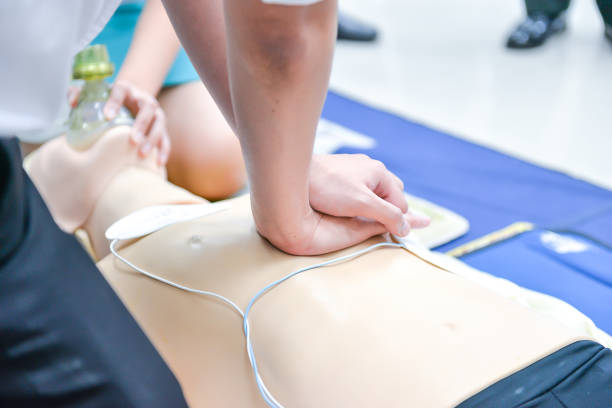 istock Basic Life Support of Demonstrating chest compressions on CPR doll 671231432