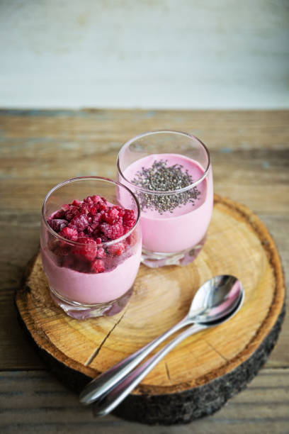 Chia raspberies cottage cheese breakfast in two small transparent glasses
