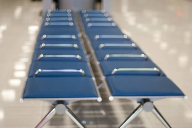 istock Blurred abstract background of empty seats at baggage carousel zone in airport 671231752