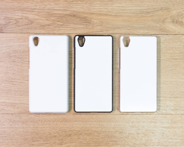 istock White phone cases on wooden background. 671231786