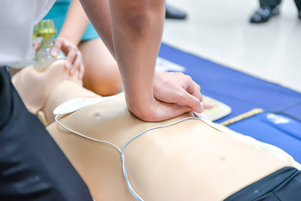 istock Basic Life Support of Demonstrating chest compressions on CPR doll 671232308