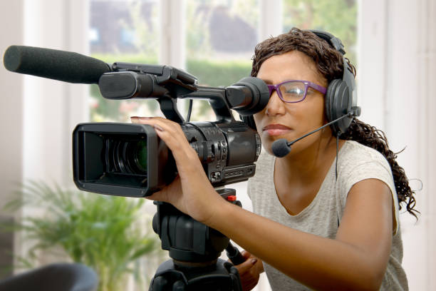istock young African American women with professional video camera 671235176