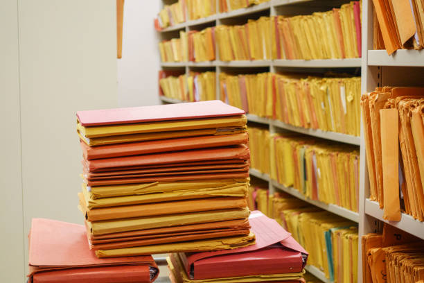 istock Stacked files in front of shelf 671241944