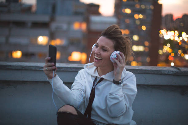 istock Woman skyping on a rooftop 671243296