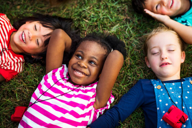 istock Diversity Group Of Kids Lying on Grass 671252696