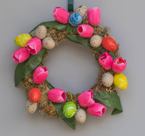 istock Colorful easter wreath hanging on door 671254280