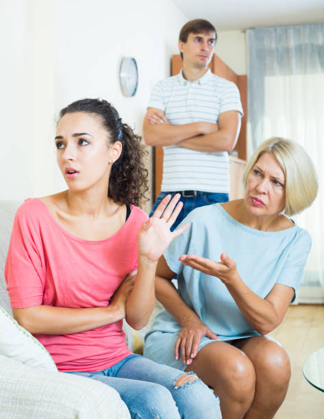istock Relatives quarrelling with young woman in domestic interior 671259452