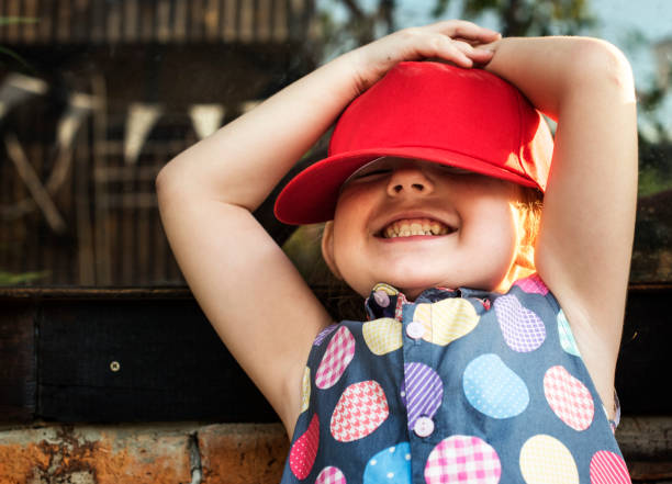 istock Girl is smiling with red cap 671260238