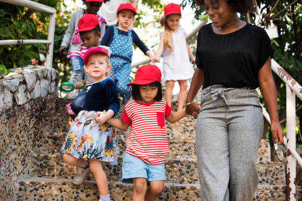 istock Teacher and kids school learning ecology gardening 671260510