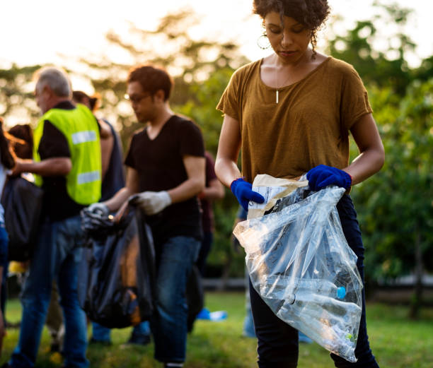 istock Ecology group of people cleaning the park 671263040