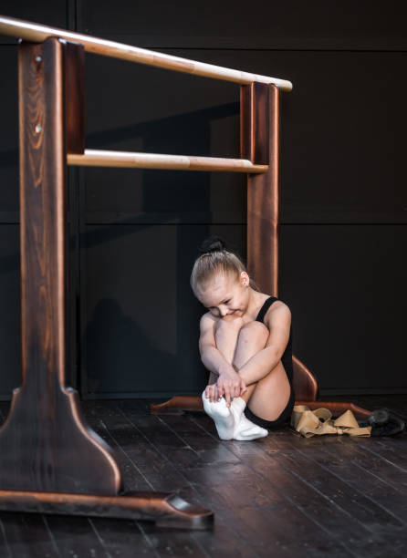 istock Little Girl Dancer Resting After Training 671264934
