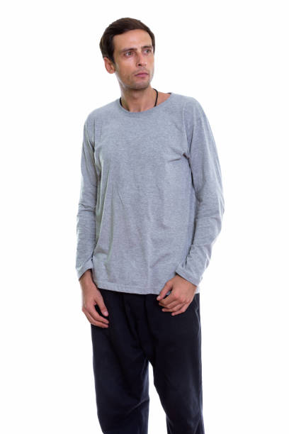 istock Studio shot of young handsome man standing and thinking while looking up 671265464