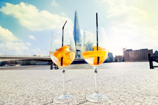 pair of cocktail glasses - in the background the Thames and the London skyline