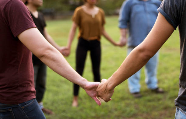 Group of people support unity arm around together