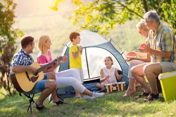 istock family playing a guitar and singing 671273926