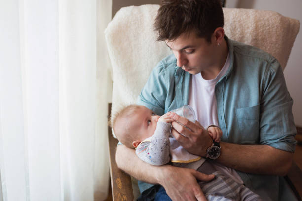 istock Young father feeding his baby 671276892