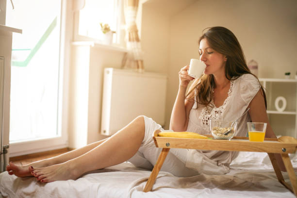 istock Young woman having breakfast in bed. 671277198