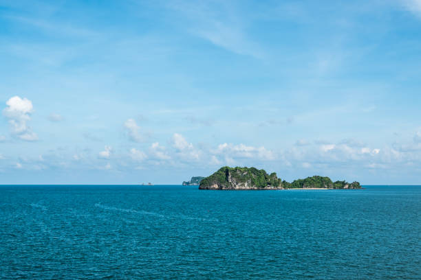 Seascape and small island with blue sky