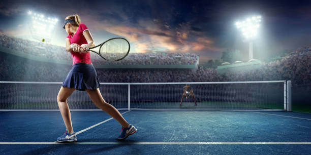 Tennis: Female sportsman in action Female sportsman is playing tennis on an outdoor stadium full of spectators. She is wearing unbranded sports cloth and using unbranded sport equipment baseline stock pictures, royalty-free photos & images