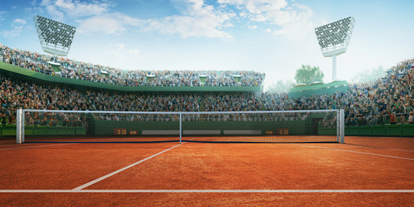 Tennis stadium with crowd on the bleachers.