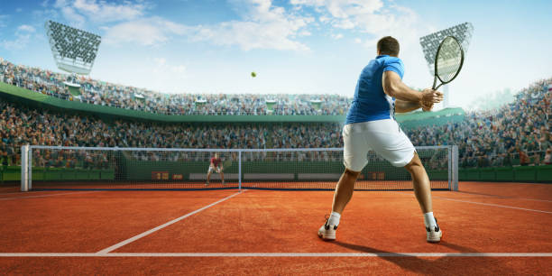 Tennis: Male sportsman in action Male sportsman is playing tennis on an outdoor stadium full of spectators. He is wearing unbranded sports cloth and using unbranded sport equipment tennis outfit stock pictures, royalty-free photos & images