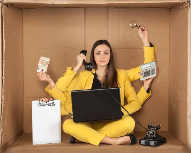 multitasking businesswoman siting in the box office