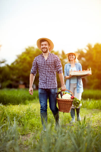 istock Farmers couple returning from garden with vegetables 671282560