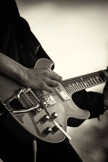 Close up of man playing a guitar stock photo