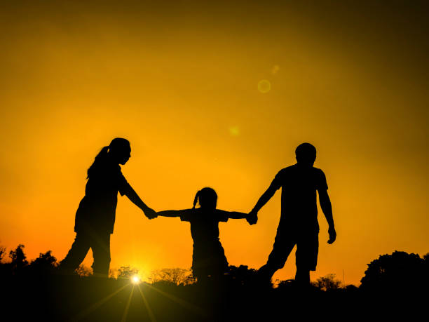 istock silhouette father, mother and daughter 671287406