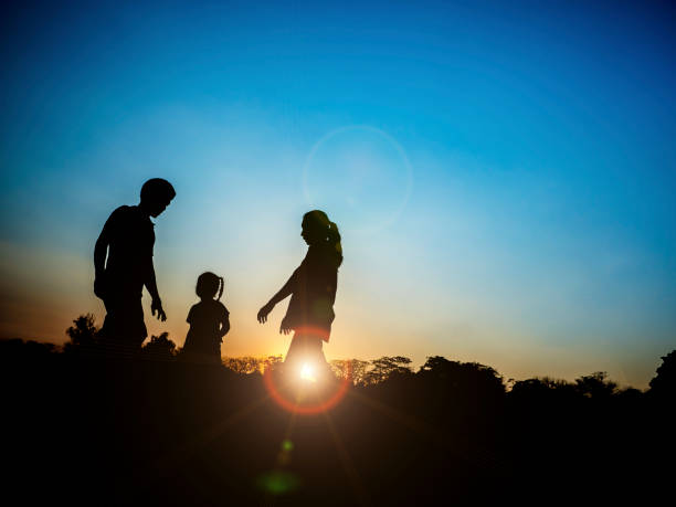 istock silhouette father, mother and daughter 671287454