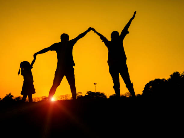 istock silhouette father, mother and daughter 671287528