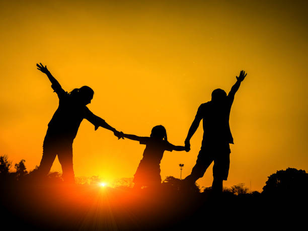 istock silhouette father, mother and daughter 671287556