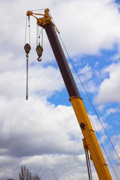 istock The boom of a construction crane with the hook. Cloudy sky background 671295100