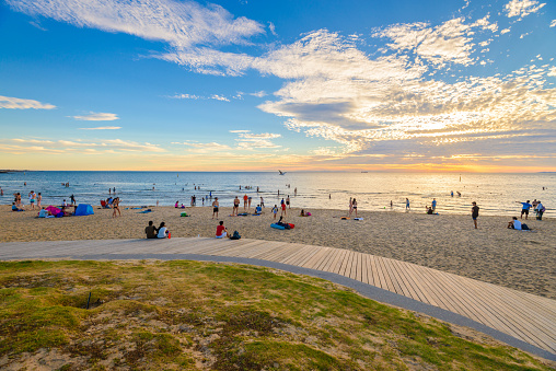 Melbourne: People spending time on St. Kilda Beach at sunset on a hot summer day, Victoria, Australia