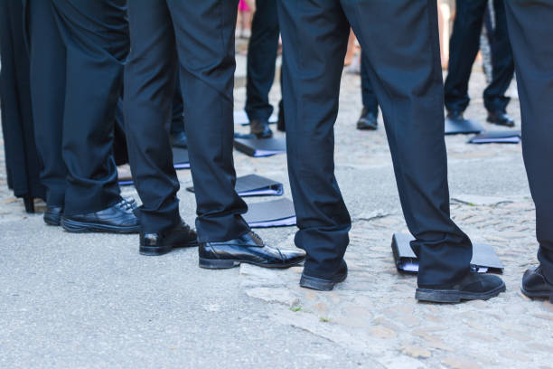 istock Man's feet in black trousers. 671303962