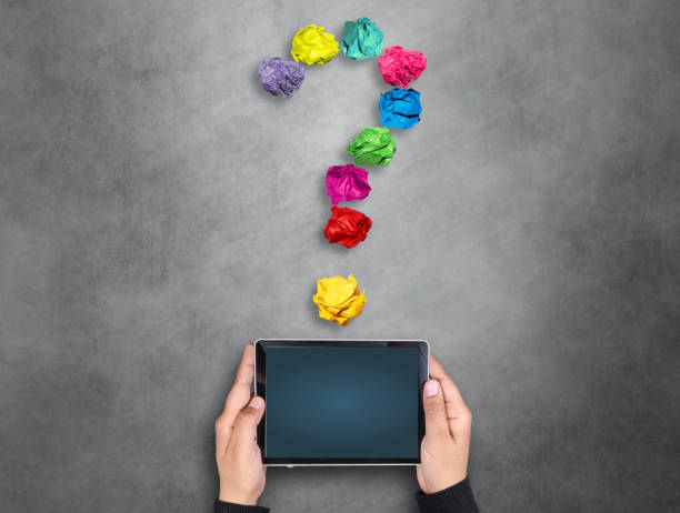 istock Businesswoman holding digital tablet under question mark 671323458