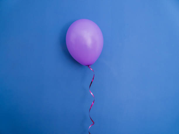 istock Single pink balloon on blue background. 671323546