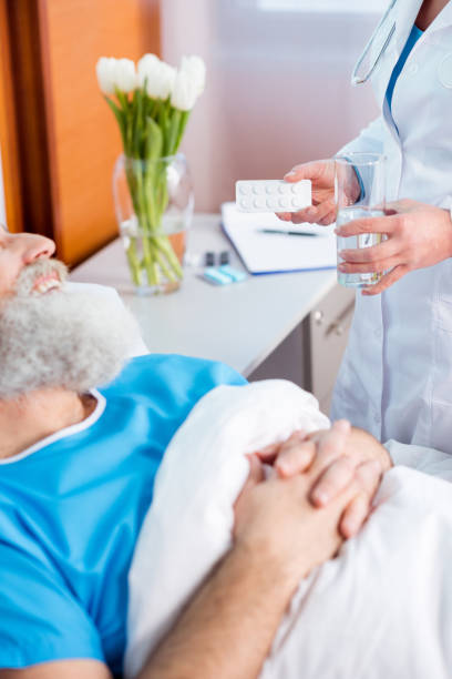 istock Doctor bringing medicine to patient 671323856