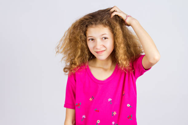 istock young girl scratching head, thinking daydreaming deeply about something 671324050