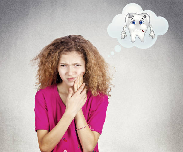 young little girl with sensitive tooth ache, crown problem touching outside mouth with hand, Closeup portrait young little girl with sensitive tooth ache, crown problem touching outside mouth with hand, isolated black grey background. Negative human emotion, facial expression feeling reaction drill end stock pictures, royalty-free photos & images