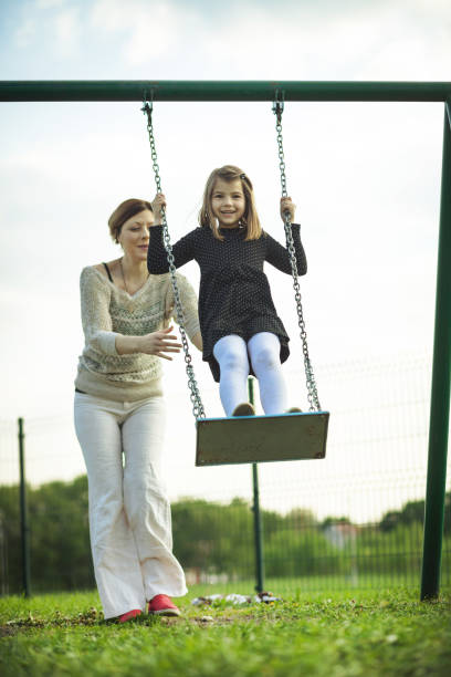 istock Happy young girl on swing 671326744